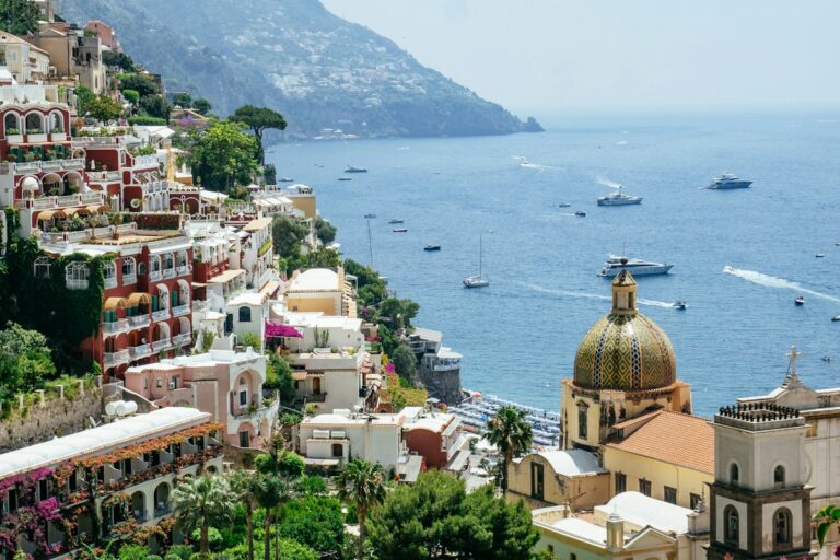 Amalfi Coast tours: aerial view of Positano and its church dome above the sea