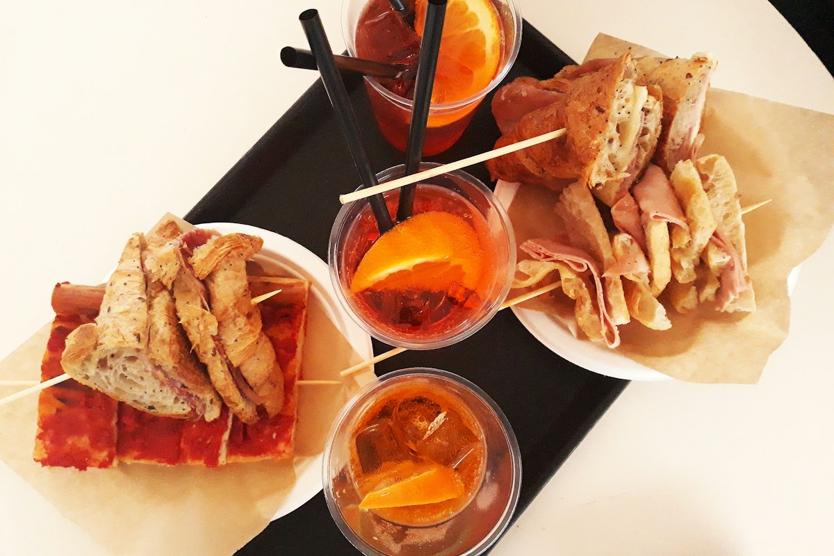 Aperitivo in Italy: a tray of snacks served with an Aperol Spritz
