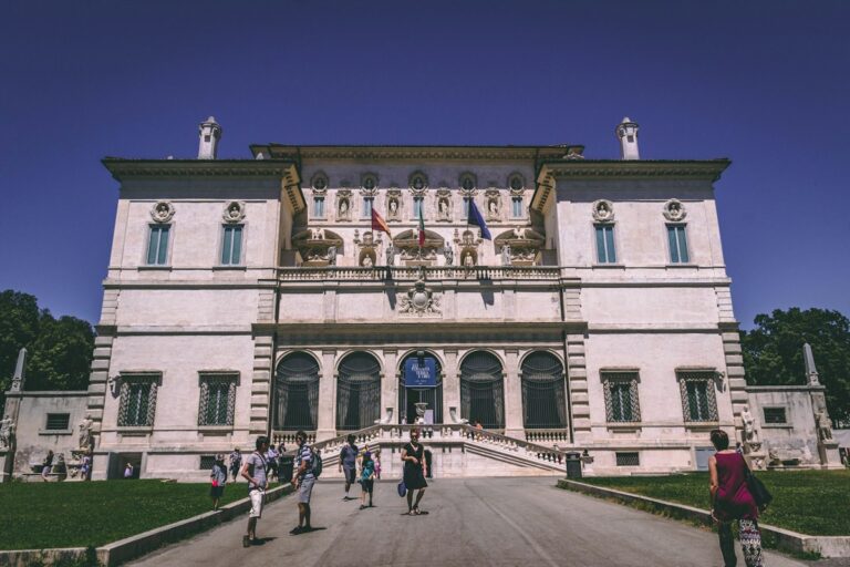 Facade of the Borghese Gallery in Rome with visitors on the path
