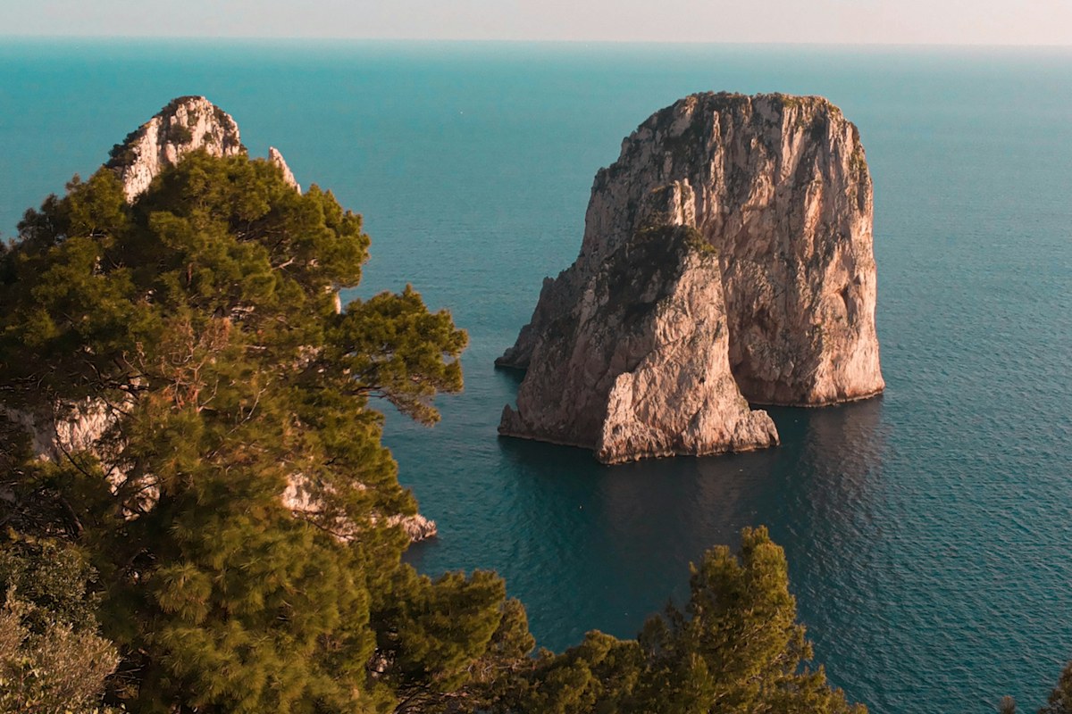 Capri tours by boat: the rock stacks off Capri in a blue sea