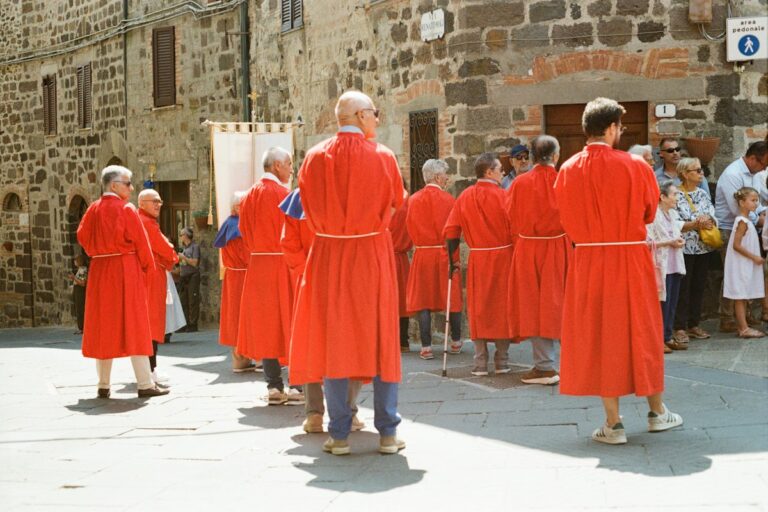 Easter in Italy: confraternity members carrying a banner in a Holy Week procession