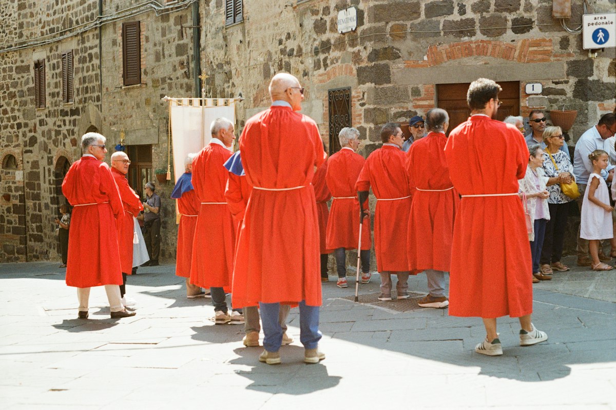 Easter in Italy: confraternity members carrying a banner in a Holy Week procession