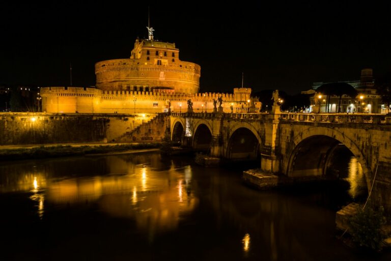 Castel Sant'Angelo reflected in the Tiber at night, a classic stop on ghost tours in Italy