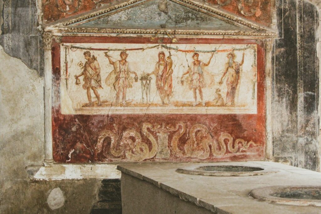 Roman fresco on a wall, a highlight when weighing Herculaneum vs Pompeii
