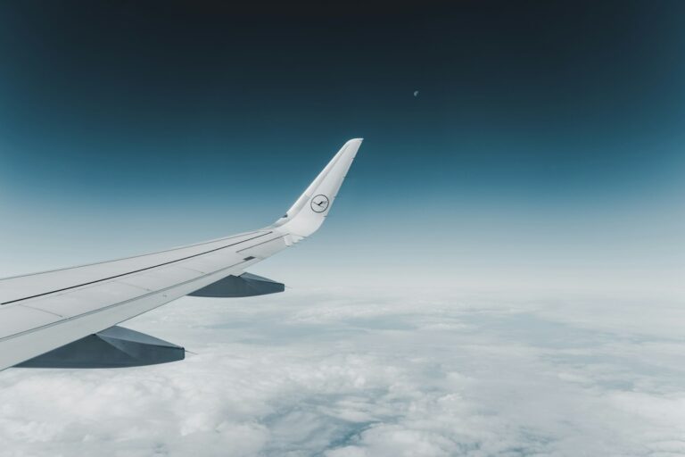 A plane flying above the clouds, as you would with Italian airlines