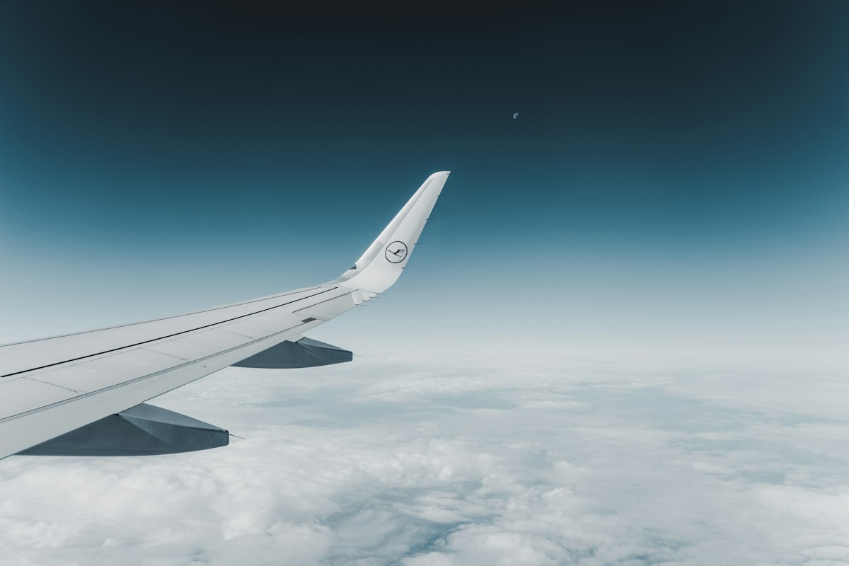 A plane flying above the clouds, as you would with Italian airlines