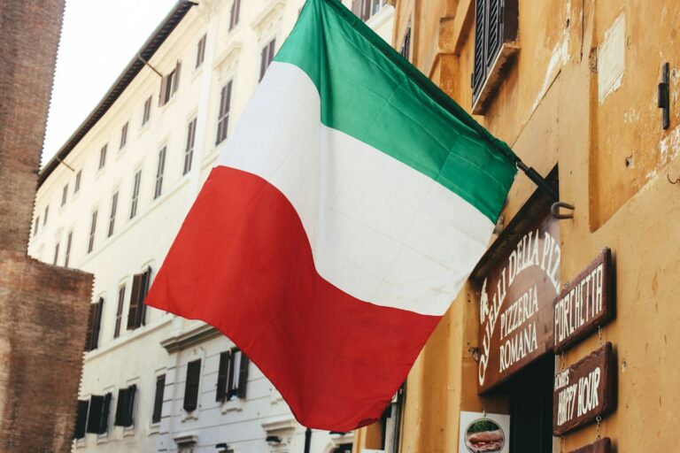 The Italian flag hanging from a building in Rome
