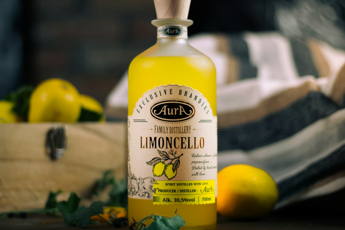 Italian liqueurs: a bottle of limoncello with fresh lemons