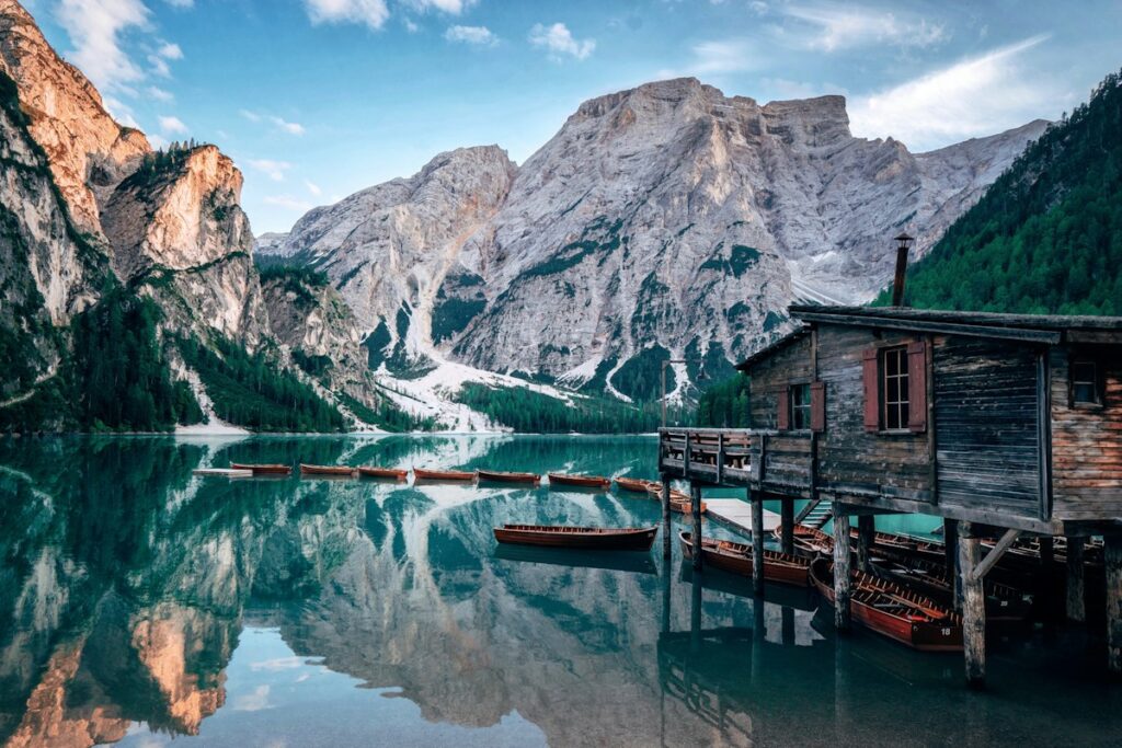Wooden boathouse on Lake Braies in the Dolomites, a cooler option for Italy in August