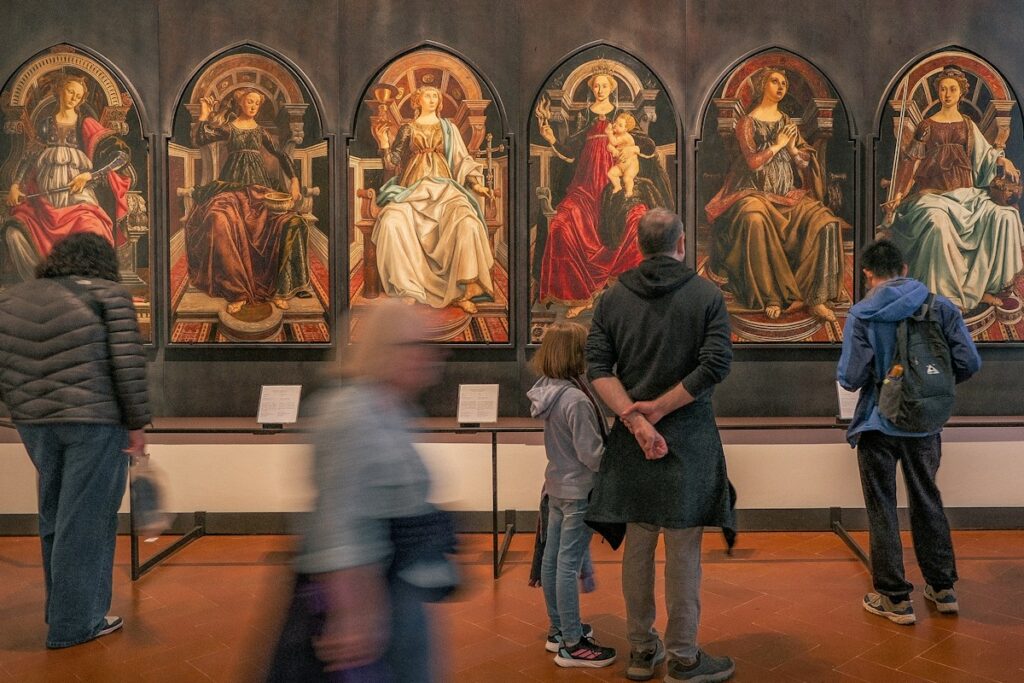 Visitors in a Florence gallery, where Italy museum ticket prices vary by site