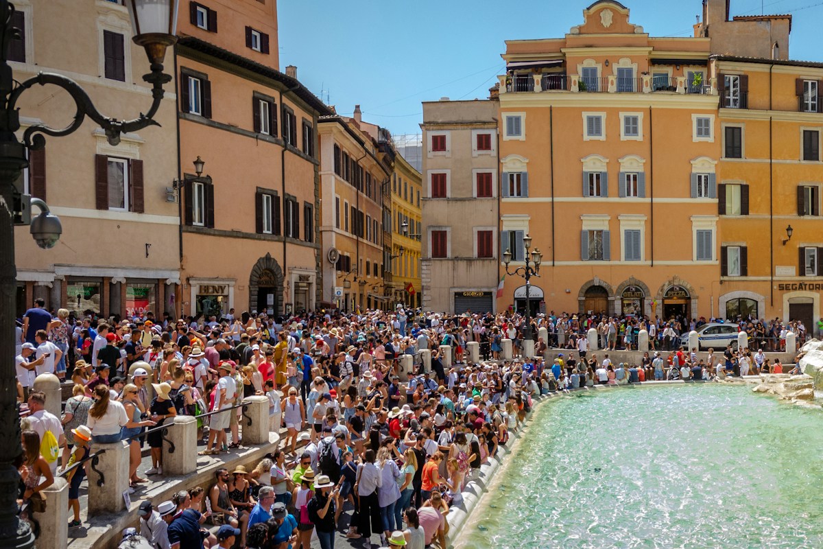 Crowds at the Trevi Fountain in Rome, where an Italy trip cost starts to add up