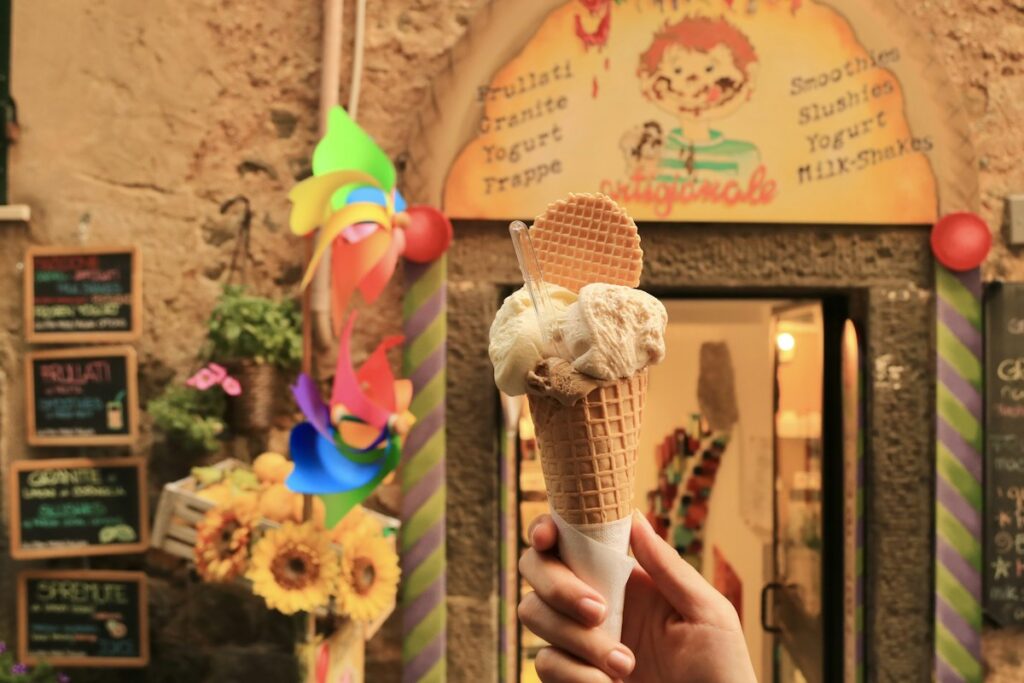 A child holding a gelato cone, a daily treat when traveling in Italy with kids