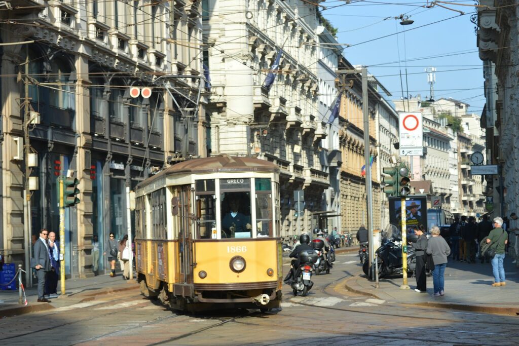 A yellow tram on a Milan street, the next step after the train from Malpensa to Milan