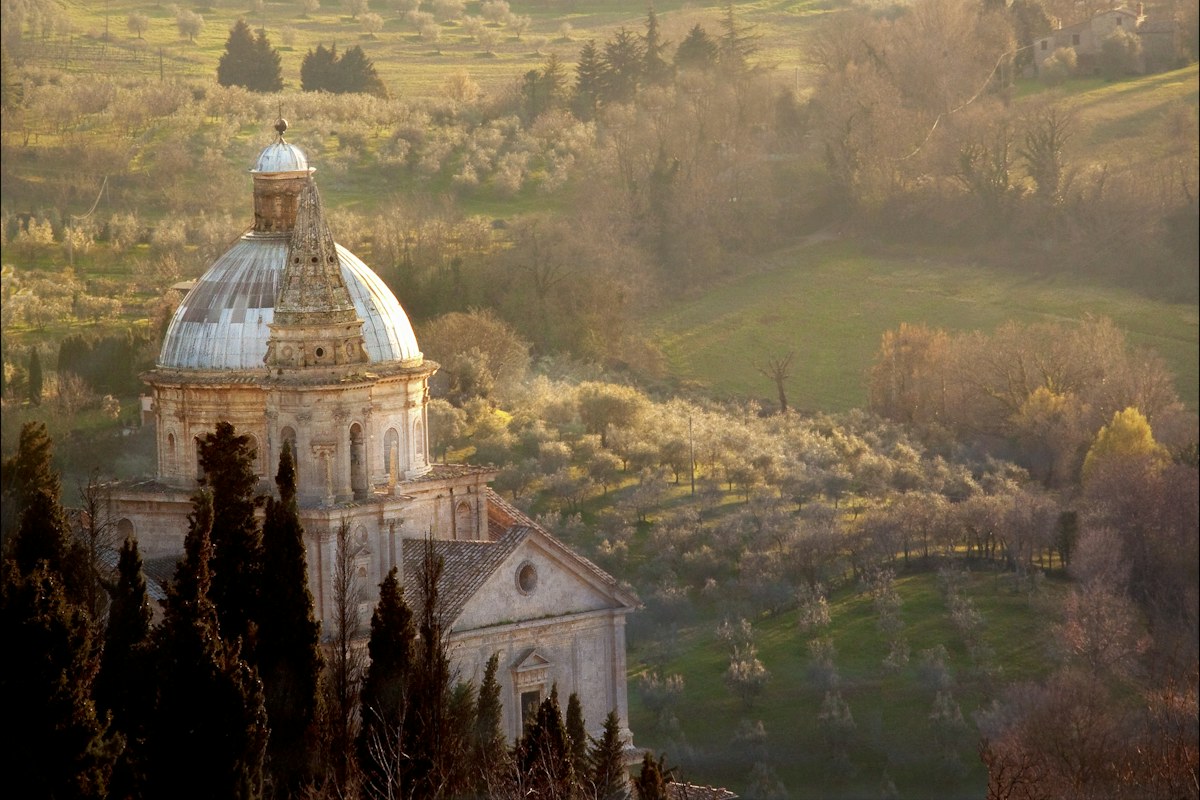 Montepulciano wine tours: a church in the green countryside of Montepulciano