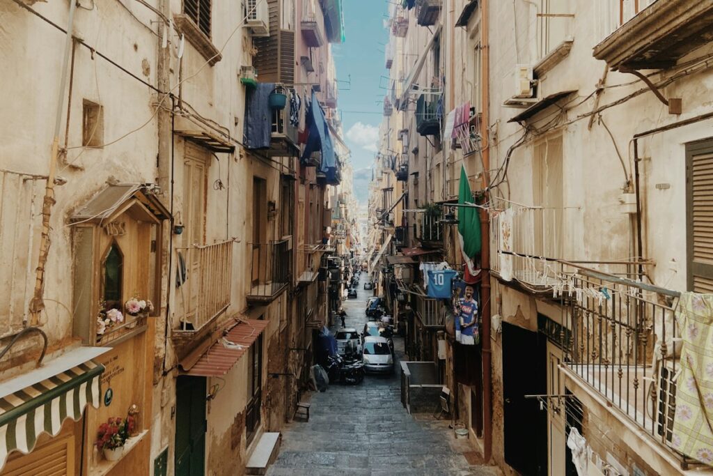 A narrow street in historic Naples, where many hotels sit after the ride from Naples airport to city center