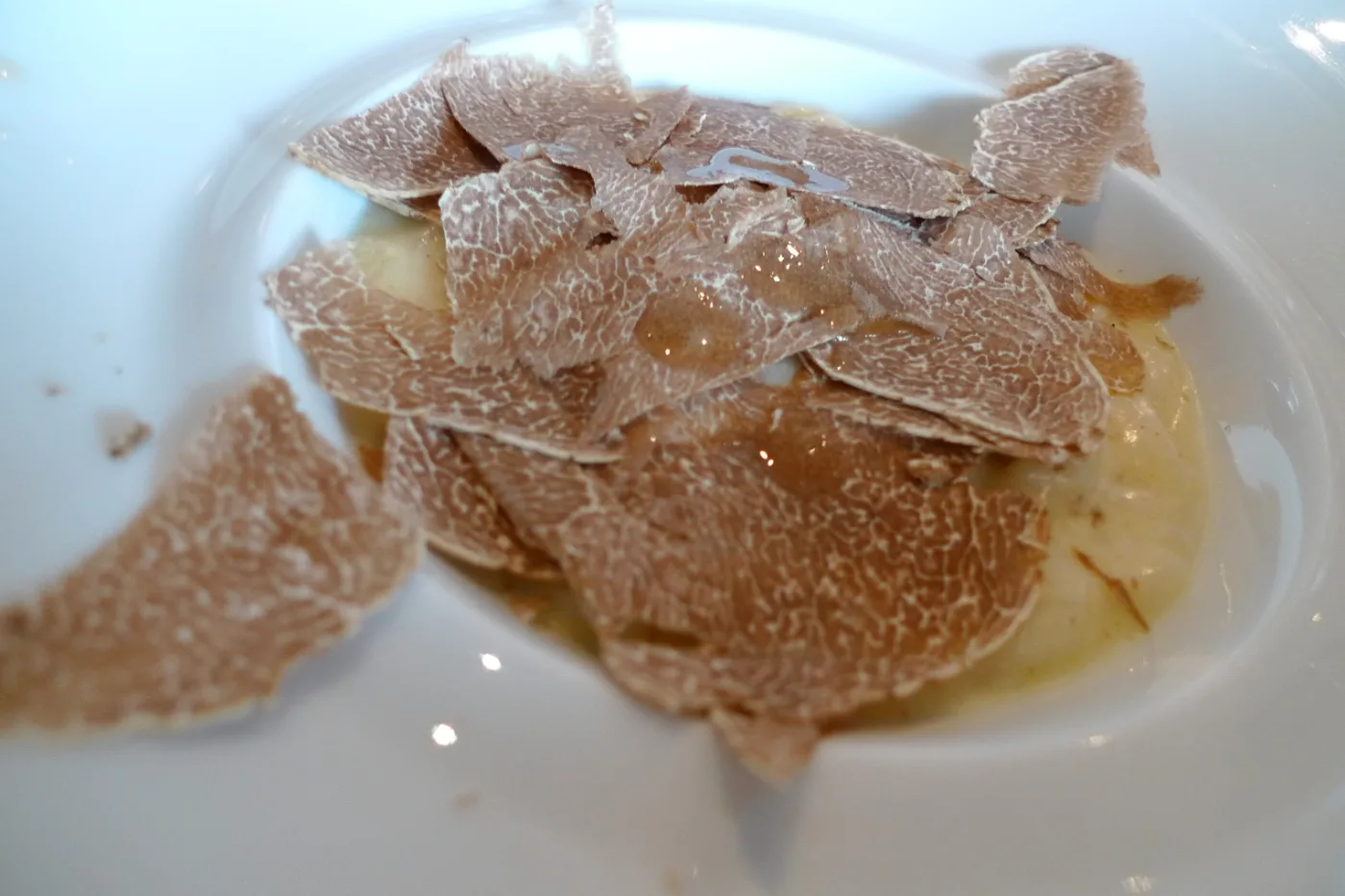 Shavings of white truffle over a plate of risotto