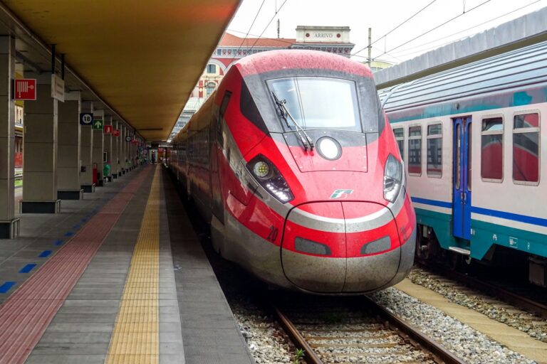 Rome to Florence train: a red high-speed train at a station platform in Italy