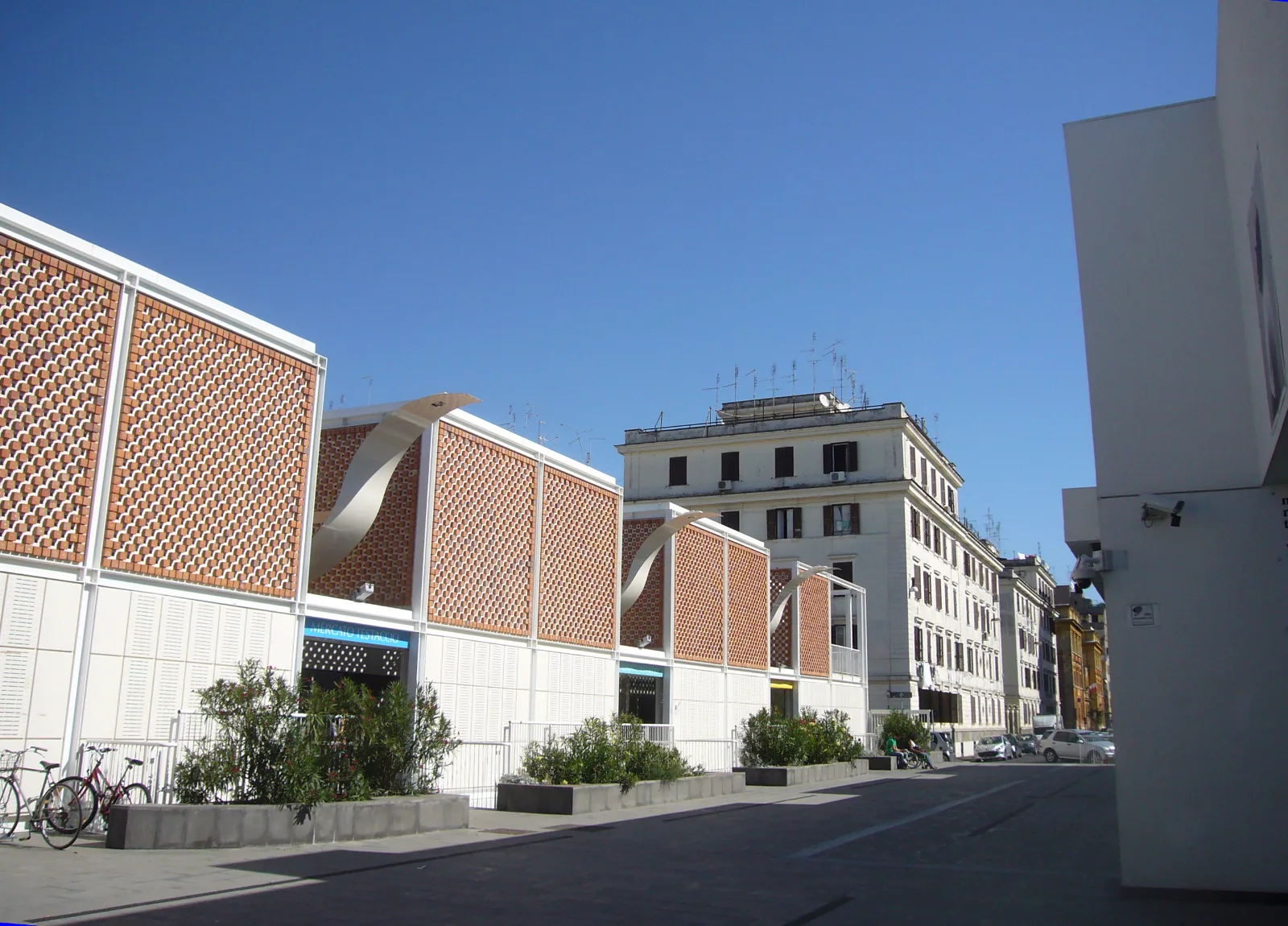 The modern white and brick facade of the Testaccio Market on a sunny day in Rome