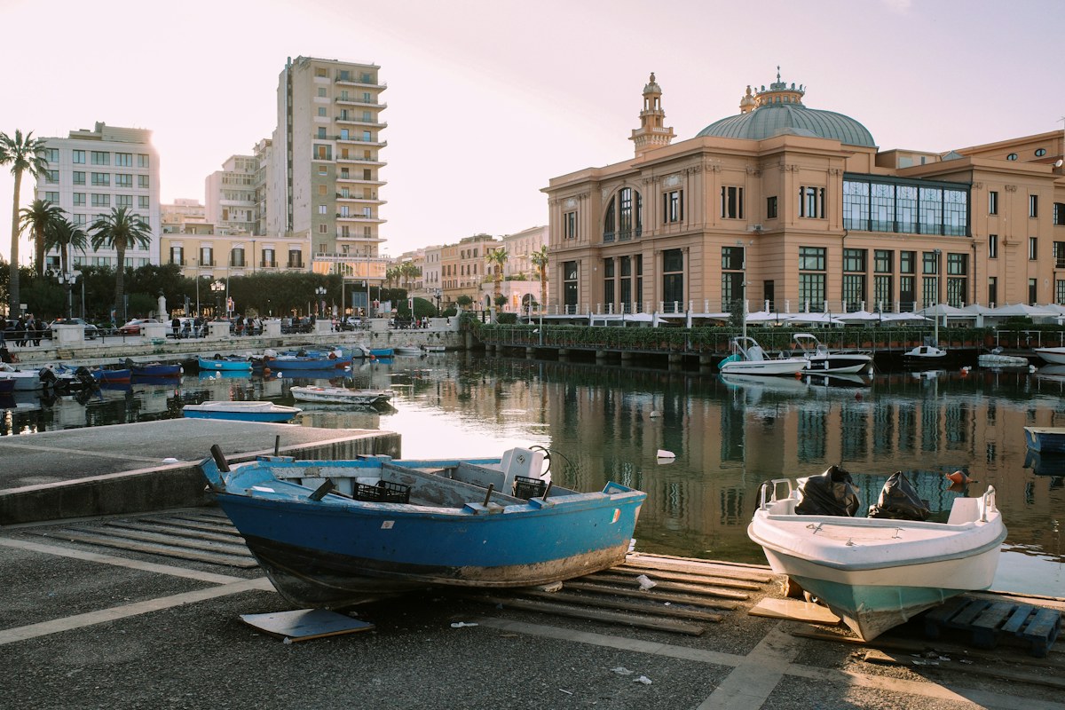 Fishing boats in the old harbor of Bari at sunset
