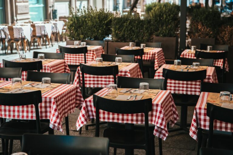 Checkered trattoria tables in Bologna, where tipping in Italy is modest