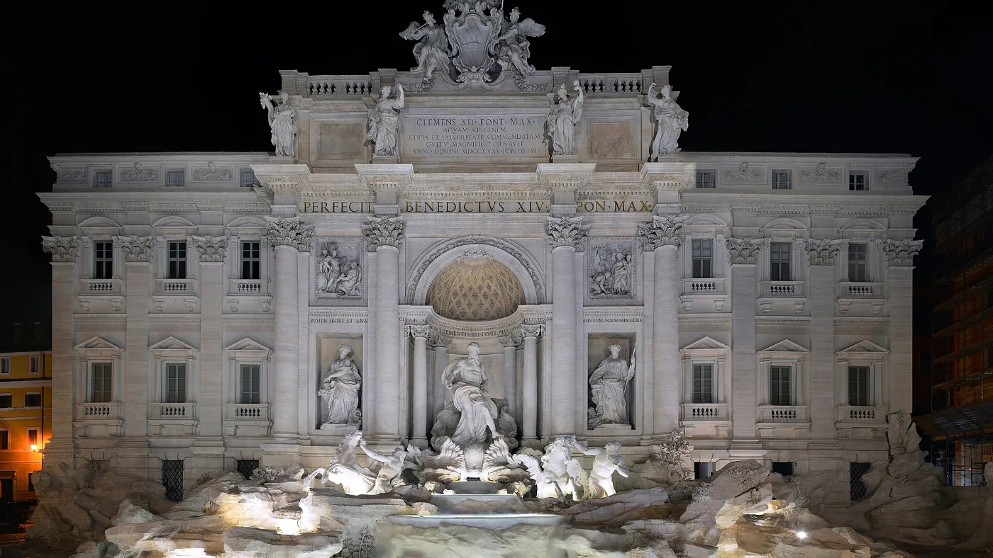 The Trevi Fountain lit up at night in Rome, a stop on New Year's Eve walks