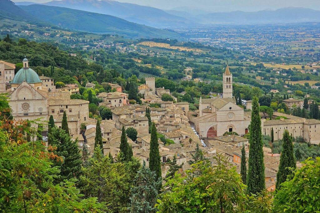 Rooftops and green hills around Assisi, a base for an Umbria itinerary