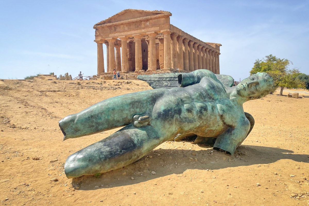 Fallen bronze statue in front of the Temple of Concordia in the Valley of the Temples