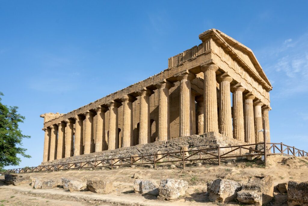 A Doric Greek temple standing under a clear sky in Agrigento