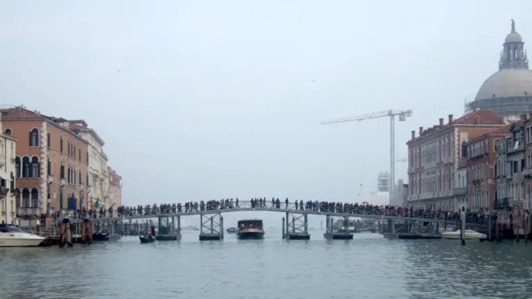 The votive bridge over the Grand Canal to Santa Maria della Salute in Venice, crowded with people in November