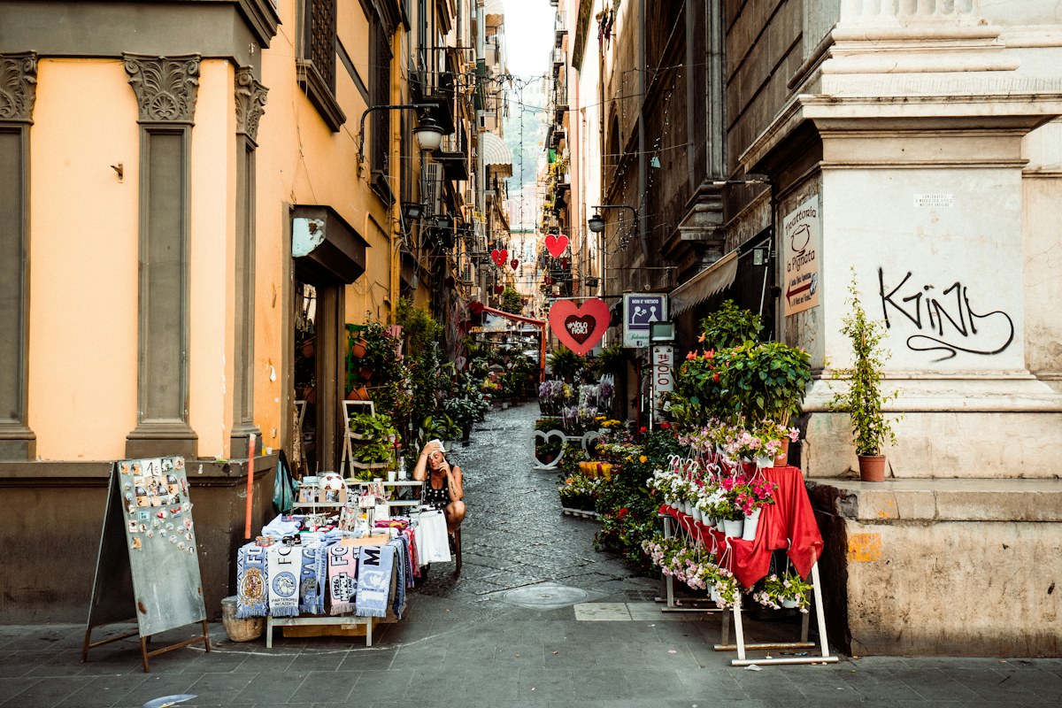 What to do in Naples: a street in the historic center with market stalls and shops