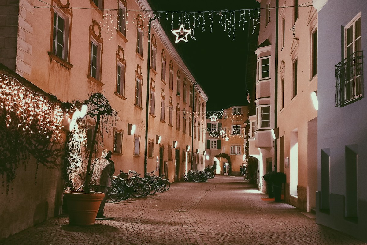 Christmas lights over a cobbled street in the old town of Bressanone (Brixen) at night
