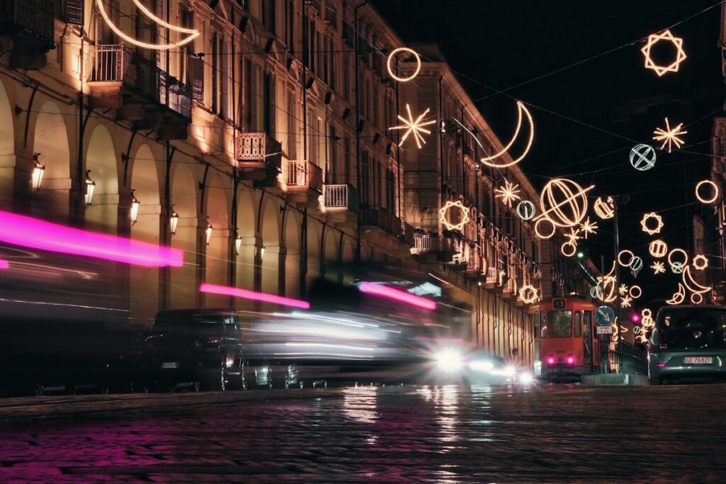 Events in Italy in December: holiday light installations over a street in Turin at night