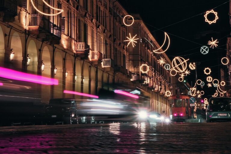 Events in Italy in December: holiday light installations over a street in Turin at night