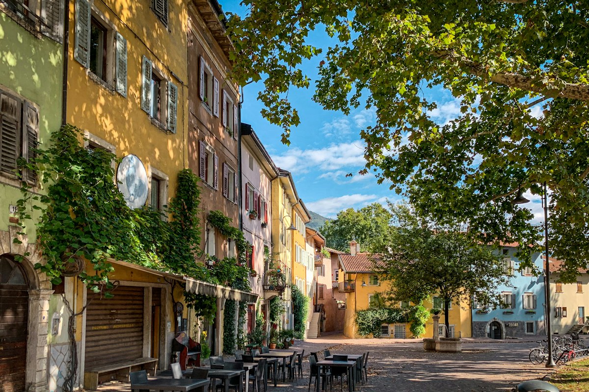 Painted houses on an old town street in Trento, which hosts the Christmas market in Piazza Fiera