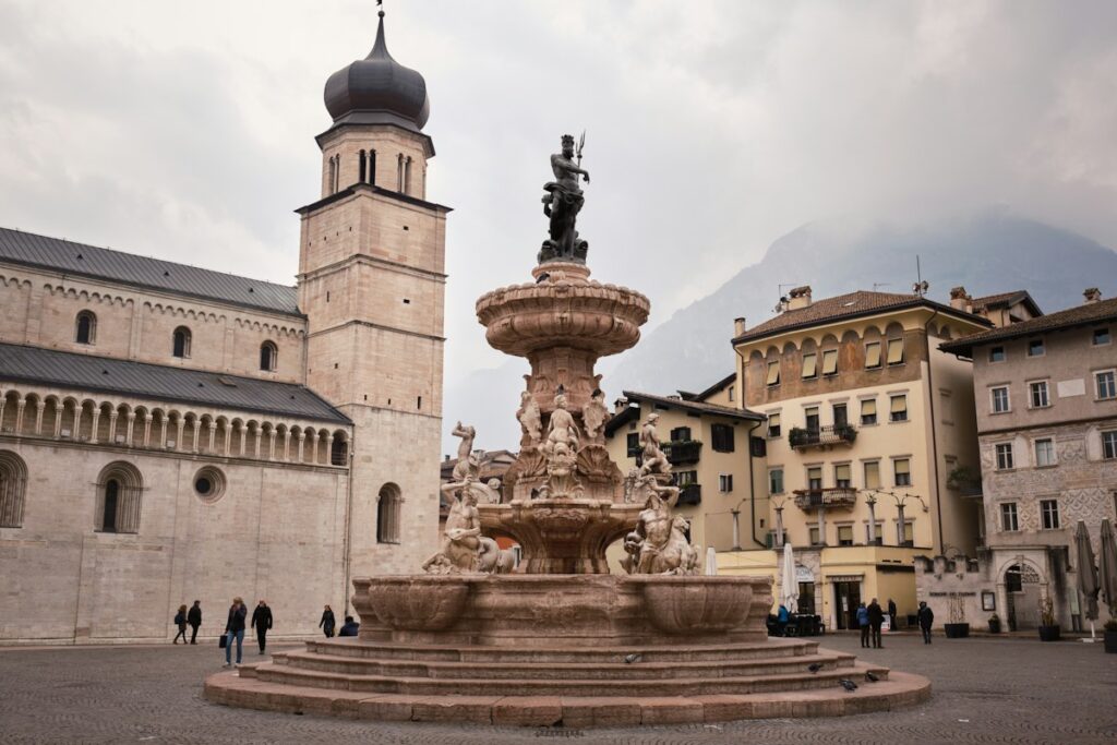 The Fountain of Neptune and the cathedral bell tower in Piazza Duomo, Trento